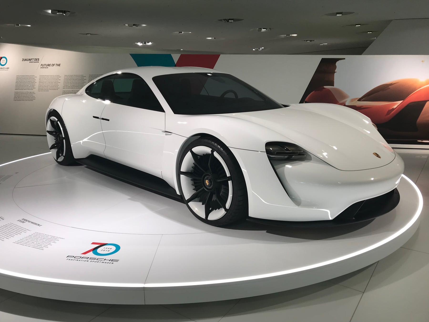 White Porsche Mission E electric concept car displayed inside the Porsche Museum