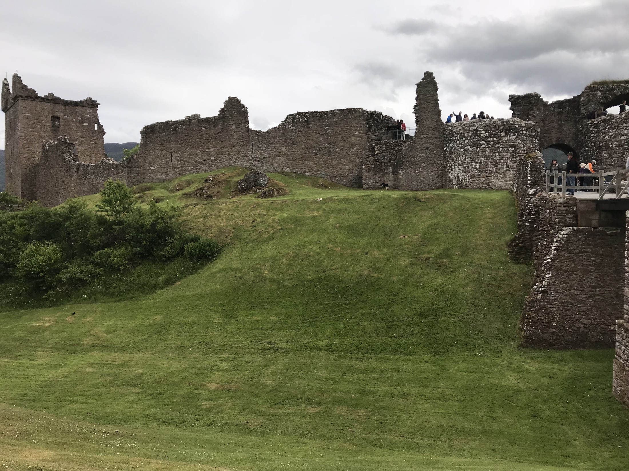 A grassy path leading uphill through the ruins of Urquhart Castle