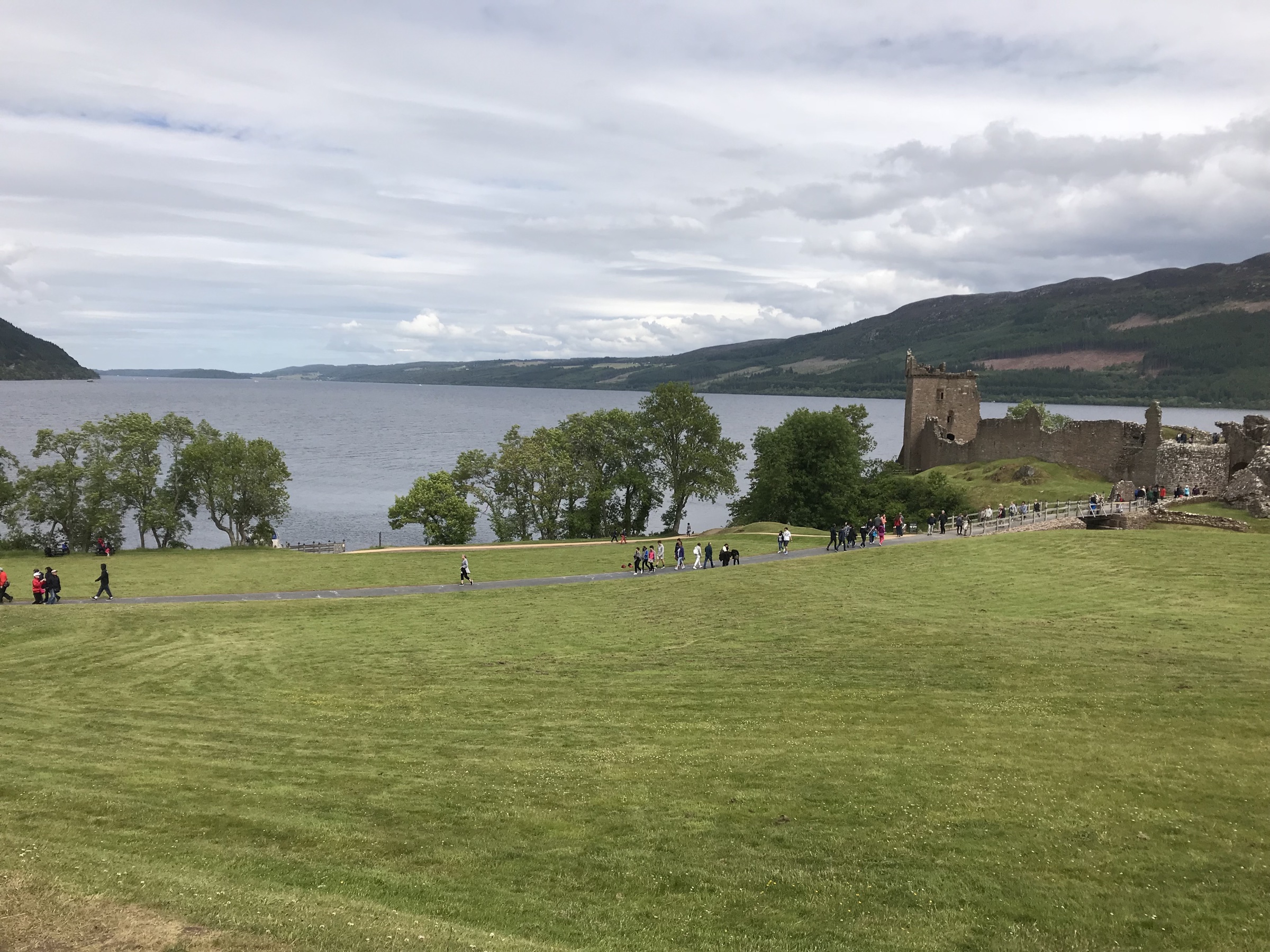 Urquhart Castle and its green grounds overlooking Loch Ness