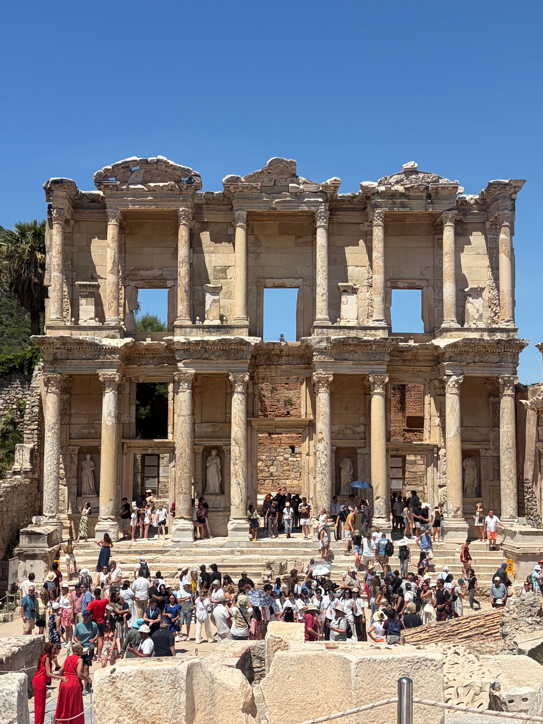 The restored facade of the Library of Celsus rising above summer crowds at Ephesus