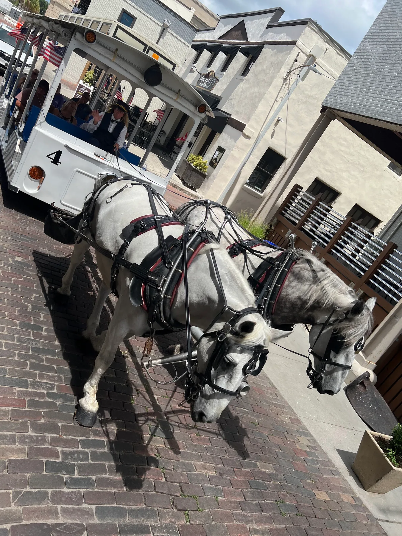 A horse-drawn carriage traveling along a brick street in historic downtown Wilmington