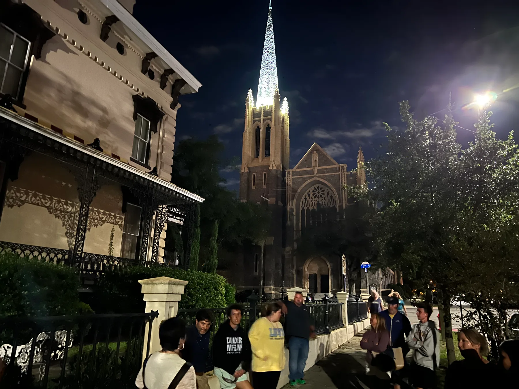A nighttime tour group outside the illuminated First Presbyterian Church on Third Street in Wilmington