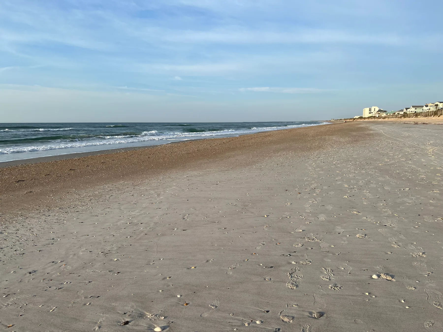 A broad, quiet stretch of sand and Atlantic shoreline at Wrightsville Beach